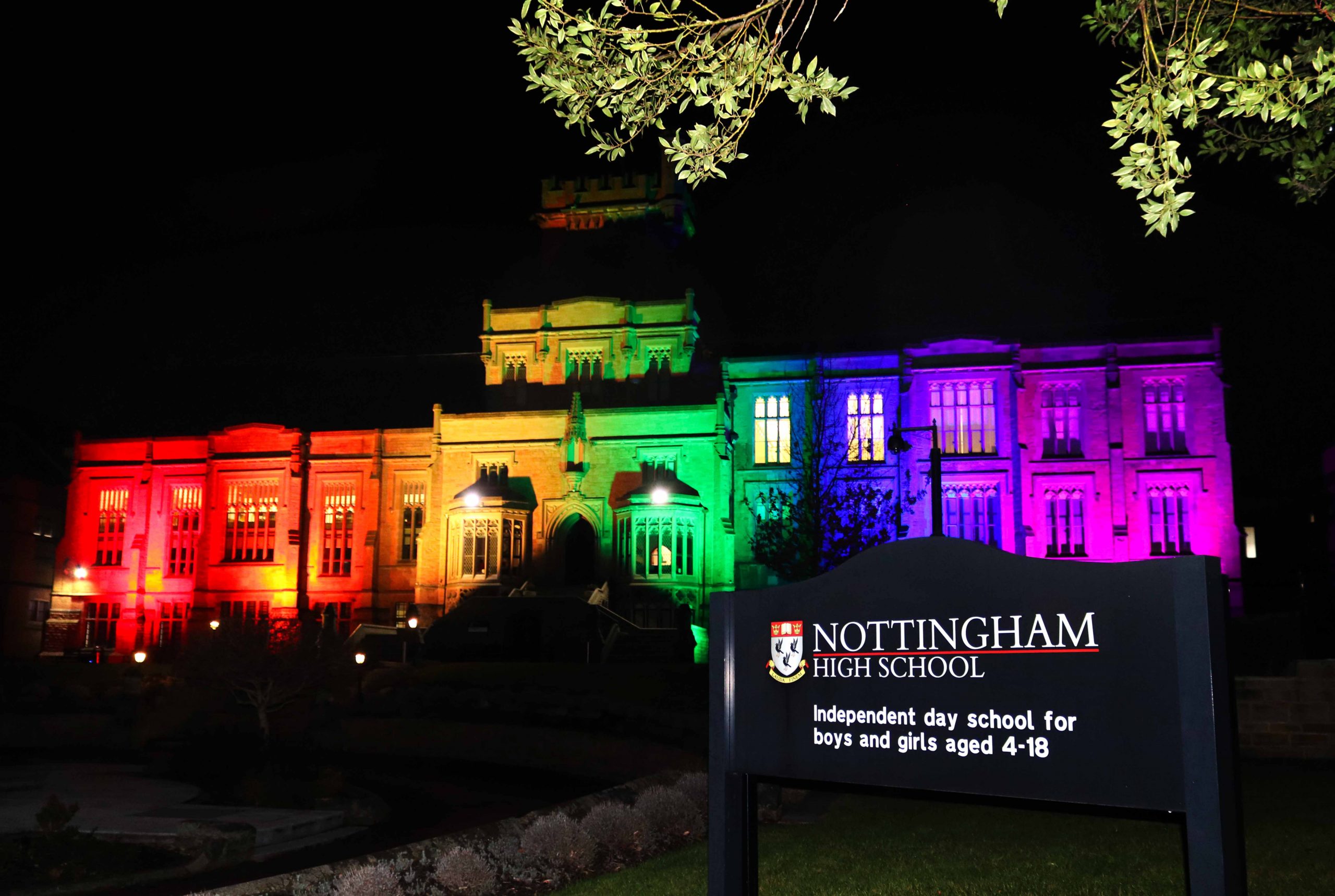 front of school lit up like a rainbow